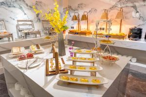 a buffet with several plates of food on a table at Xi'an Xichen Hotel in Xi'an