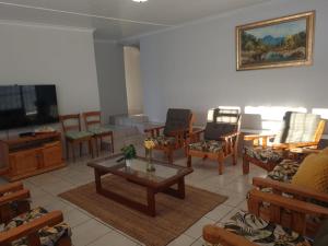a living room with chairs and a coffee table at Kom ma nader in Velddrif