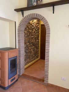 an archway in a room with a stone wall at La Casa Dei Fiori in Tolfa