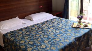 Postel nebo postele na pokoji v ubytování Hotel Altavilla Dieci