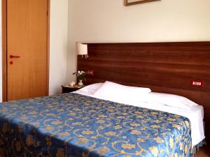 Postel nebo postele na pokoji v ubytování Hotel Altavilla Dieci