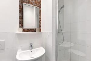 a white bathroom with a sink and a shower at Albrechtshof Zimmer Parkblick 3 in Neu Fahrland