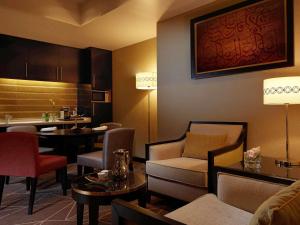 a hotel room with a kitchen and a living room at Pullman Zamzam Madina in Al Madinah