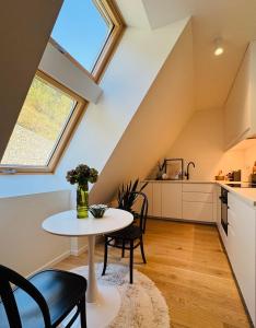 a kitchen and dining room with a table and chairs at Chic Loft by Castle&Danube Old town Free Parking in Bratislava