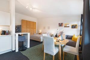 a living room with a table and a bedroom at Studio-Apartment in Neu Fahrland