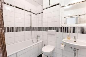 a white bathroom with a toilet and a sink at Studio-Apartment in Neu Fahrland +16 photos