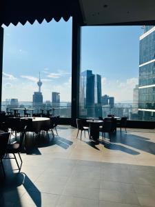 a cafeteria with tables and chairs and a view of the city at 8 Kia Peng by 8 Suites kL in Kuala Lumpur +81 photos