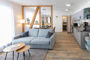 a living room with a couch and a table at Pension Alter Hirsch in Pfalzgrafenweiler