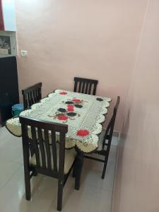 a table with two chairs and a tablecloth on it at Vrundavan 2 BHK bungalow in Pune