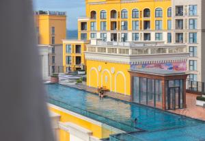 a view of a pool in a city with buildings at Solara Apartment Firework & Sunset View in Phú Quốc
