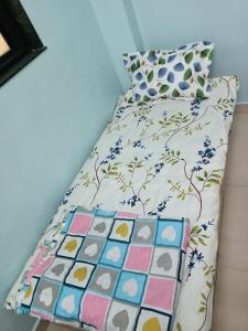 a bed in a room with a bedspread and pillows at Vrundavan 2 BHK bungalow in Pune