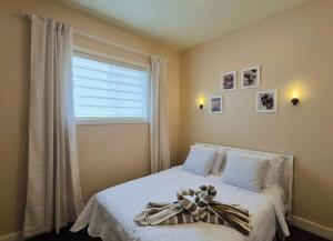 a bedroom with a bed with a teddy bear on it at Central 3 Bedroom Gem Near ICE District - Stadium and Malls in Edmonton