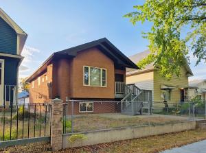 a house with a fence in front of it at Central 3 Bedroom Gem Near ICE District - Stadium and Malls in Edmonton