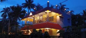 a large house with a balcony at night at Sandhyamalati Homestay and Picnic Ground 