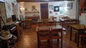 a restaurant with wooden tables and chairs in a room at Auberge Du Bon Coin in Moulins-Engilbert