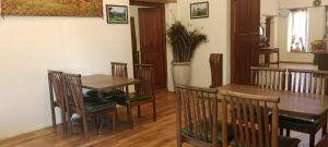 a dining room with a table and chairs at Ksr woodland Residency in Kodaikānāl