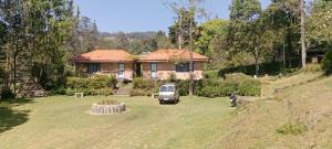 a van parked in front of a house at Ksr woodland Residency in Kodaikānāl