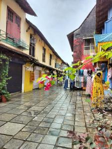 a street with a group of buildings with kites at Honza Hostel in Cochin +14 photos