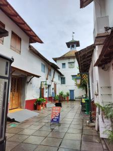 a building with a sign in the middle of a courtyard at Honza Hostel in Cochin
