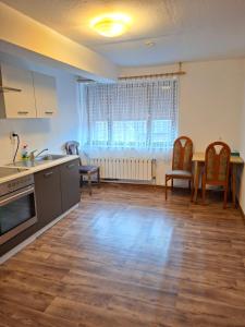 a kitchen and dining room with a table and chairs at Royal Guest House Apartment in Mönchengladbach