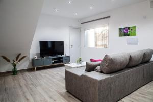 a living room with a couch and a flat screen tv at Casa Molino San Antonio in Córdoba