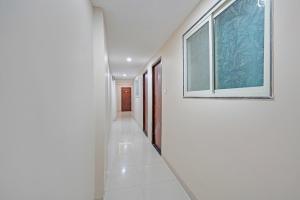 pasillo con ventana y pared blanca en FabHotel Elite Inn I, en Indore