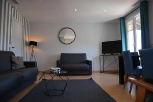 a living room with a couch and a table at Hôtel Florida in Biarritz