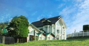 a large white house with a black roof at Oak Ray Misty Hills in Nuwara Eliya