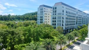 an aerial view of two tall white buildings at Monstera Hotel and Coffee in Phú Quốc