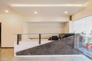 an office lobby with a glass counter top at Hotel O Meridian in Bijāpur +20 photos