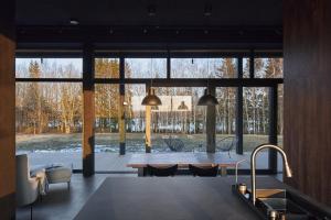 a kitchen with a table and a large window at The Barn in Deveniai