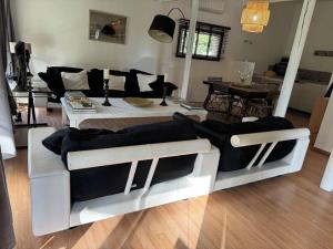 a living room with two couches and a table at le domaine des cigales in Cavaillon +1 photo
