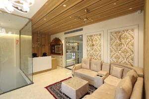 a living room with a couch and a table at Kumaran Grand - Luxury Rooms in Madurai