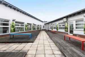 an empty courtyard of a building with benches at Albrechtshof Zimmer Parkblick 3 in Neu Fahrland +13 photos