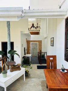 a living room with a wooden table and chairs at Villa Yehinsa - Galle Fort in Galle