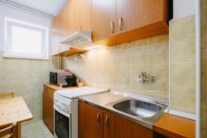 a small kitchen with a sink and a microwave at B-G Apartments in Gheorgheni