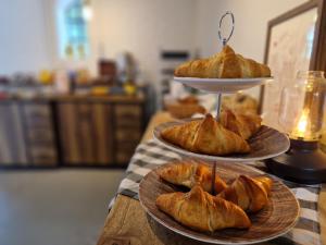 a three tiered tray of croissants on a table at Fontänens Bed & Breakfast in Trelleborg