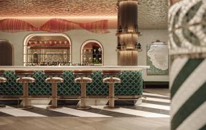 a restaurant with a bar with stools in a room at Swissôtel Marianske Lazne in Mariánské Lázně +8 photos