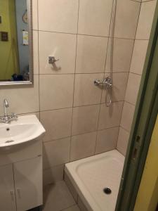 a bathroom with a shower and a sink at Plaka Rooms in Athens +11 photos