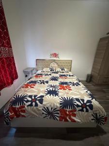 a bedroom with a bed with a quilt on it at Modern & Comfortable City Center Oasis~King Bed ! in Brussels