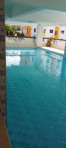 a swimming pool with blue water in a building at Lee's Mombasa Havenstays in Kanga