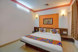 a bedroom with a large bed in a room at FabHotel Ajinkya Executive in Pune