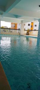 a swimming pool with blue water in a building at Lee's Mombasa Havenstays in Kanga +14 photos