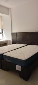 a bed in a room with a large mattress at Lee's Mombasa Havenstays in Kanga