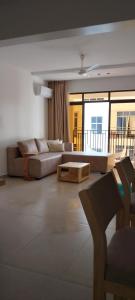 a living room with a couch and a table at Lee's Mombasa Havenstays in Kanga