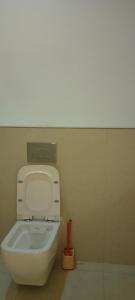 a bathroom with a white toilet with a tank at Lee's Mombasa Havenstays in Kanga +14 photos