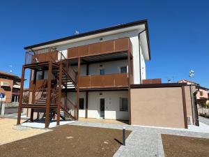 a building with a staircase on the side of it at Residence Corte Astrale in Sesto al Reghena