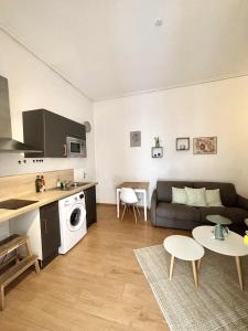 a living room with a couch and a table at Charment studio dans le centre ville de Dieppe in Dieppe +1 photo
