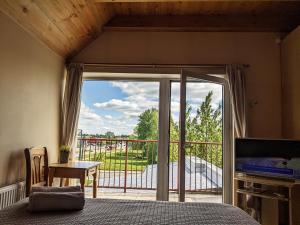a bedroom with a bed and a sliding glass door at Guest House Kamara in Panevėžys