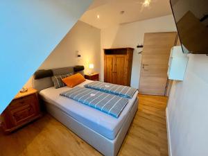 a bedroom with a bed and a wooden floor at Ferienwohnung Seeblick in Bad Bodenteich